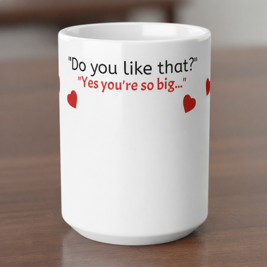 White mug with humorous text and heart designs on a wooden surface